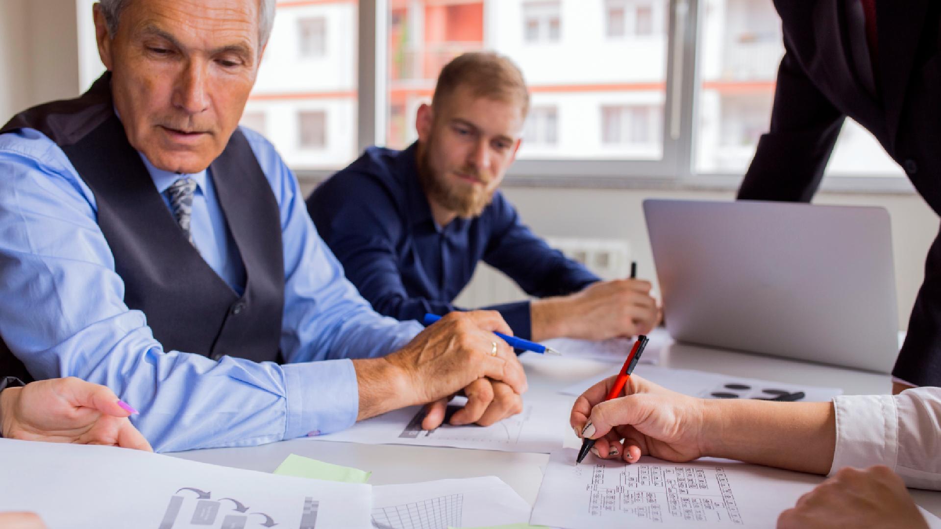 business-people-discussing-charts-graphs-table-meeting